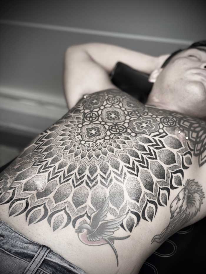 Ornate chest tattoo by Simon Halpern