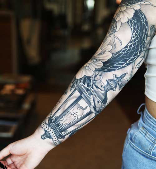 Arm sleeve tattoo by Hunter Schuon