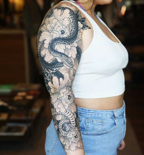 Dragon arm sleeve tattoo by Hunter Schuon
